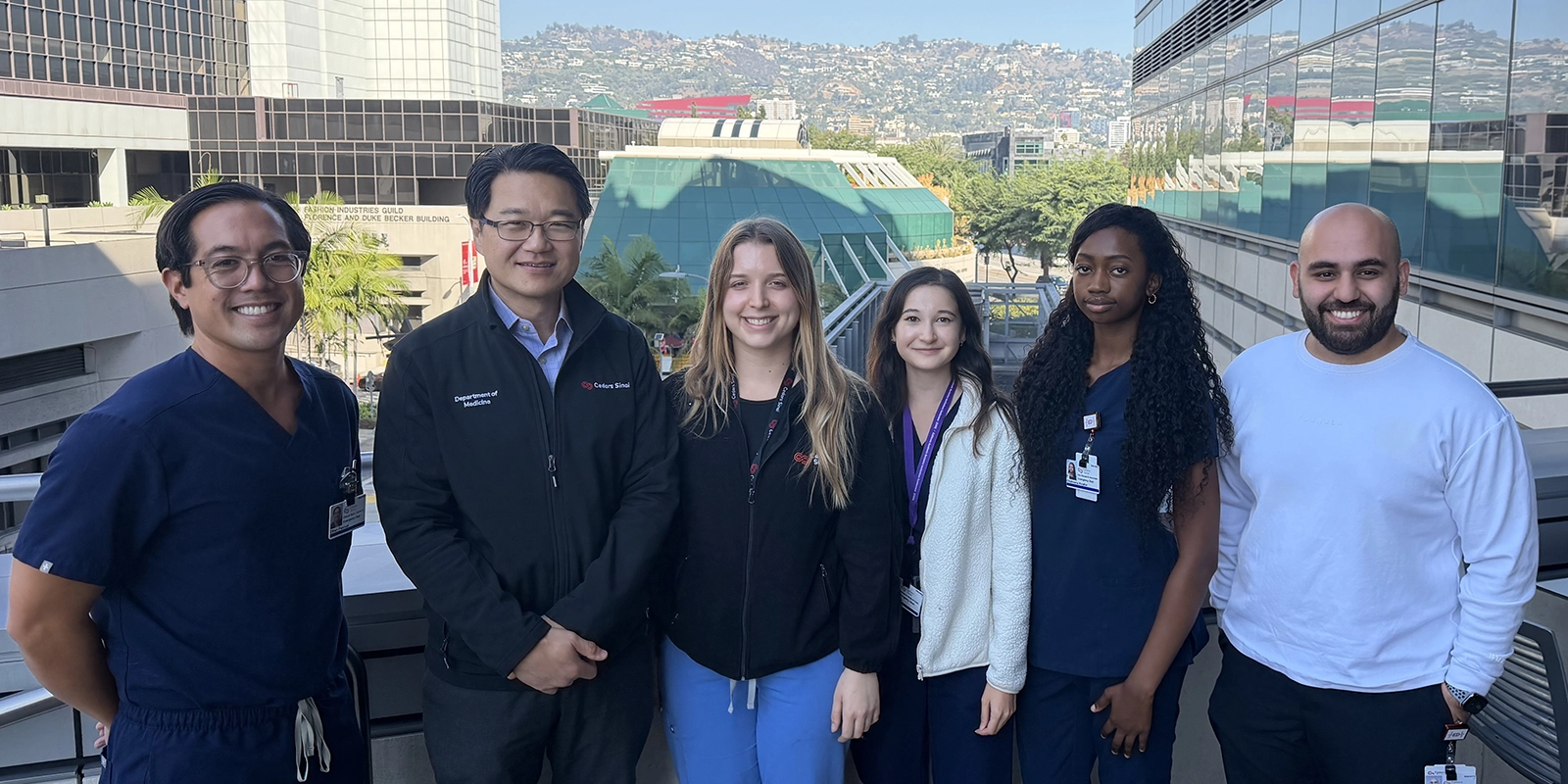 Six site staff who work on RECOVER-AUTONOMIC pose outside a building at Cedars-Sinai in Los Angeles, California.