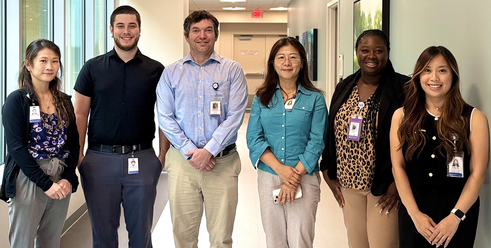 Six members of the site staff working on RECOVER-SLEEP pose in a hallway at Jadestone Clinical Research in Silver Spring, Maryland.