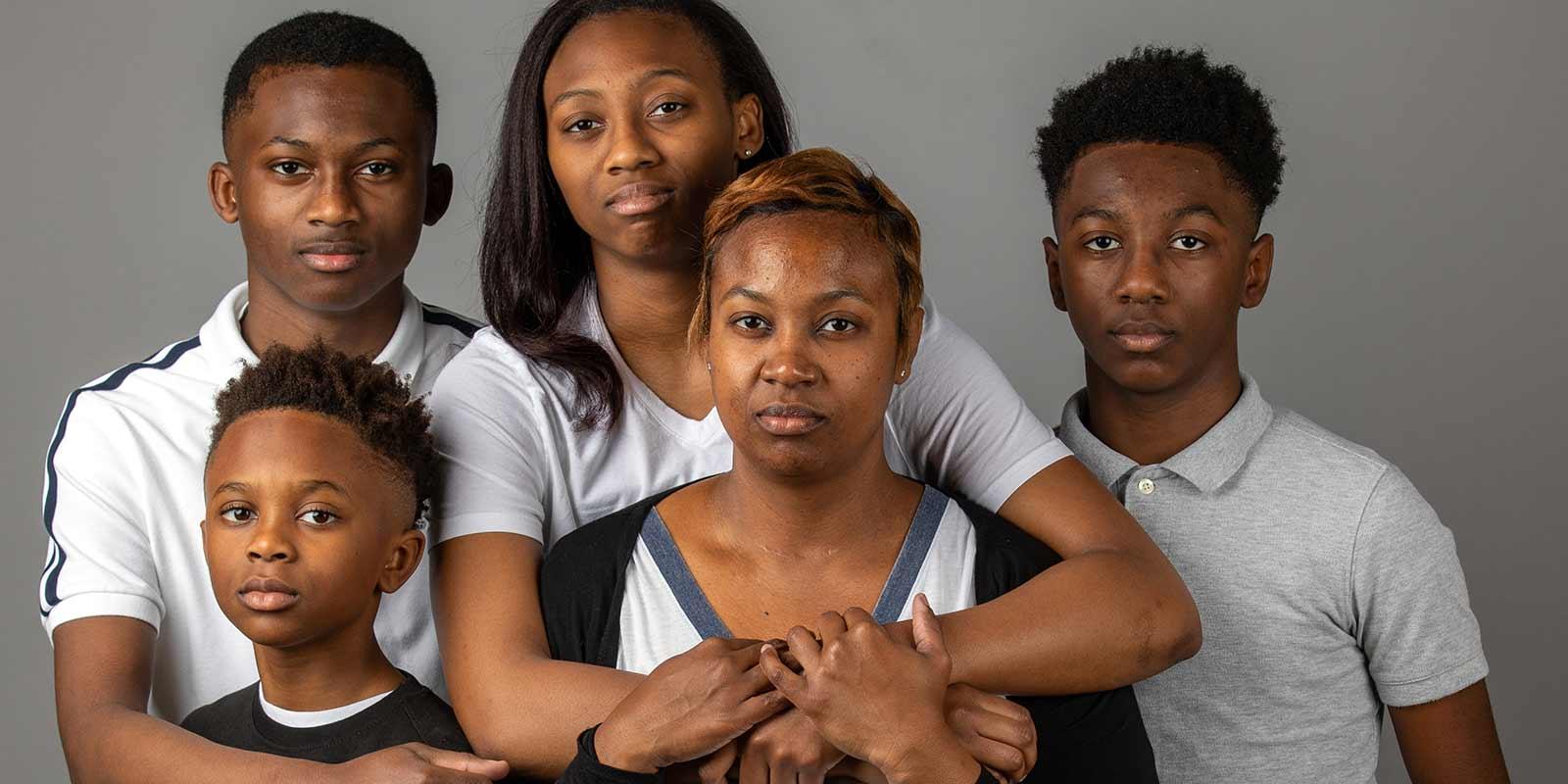 A family standing together looking at the camera