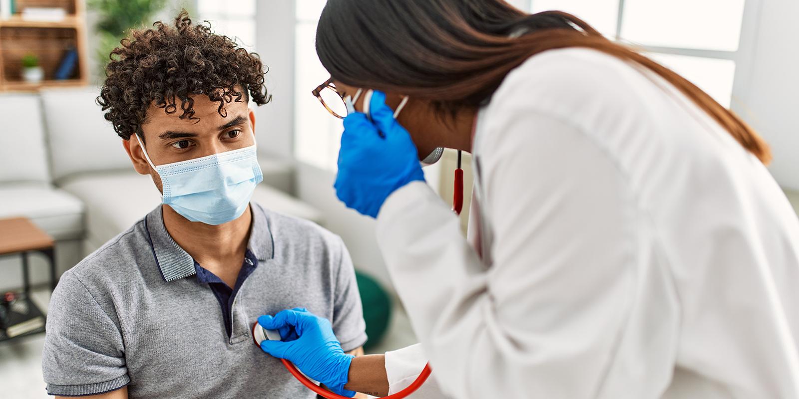 A doctor listening to a patient's chest with a stethoscope